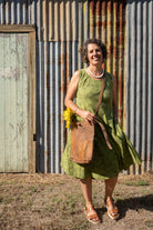 Brown leather bag and woman in green dress