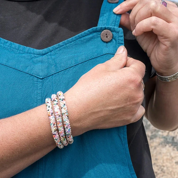 person wearing beaded bracelet