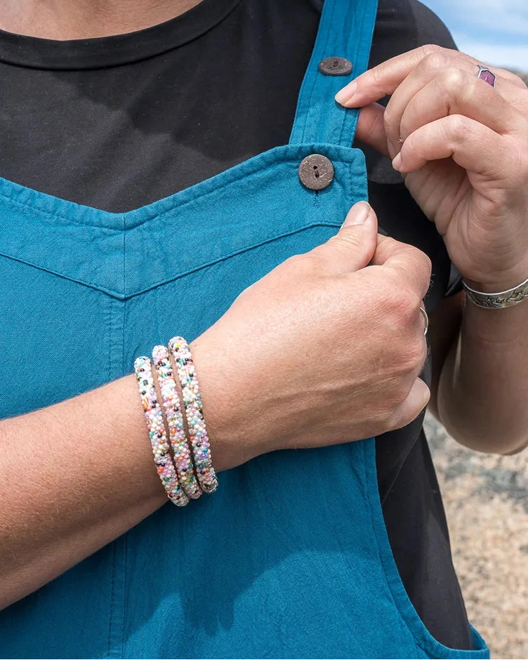 person wearing beaded bracelet