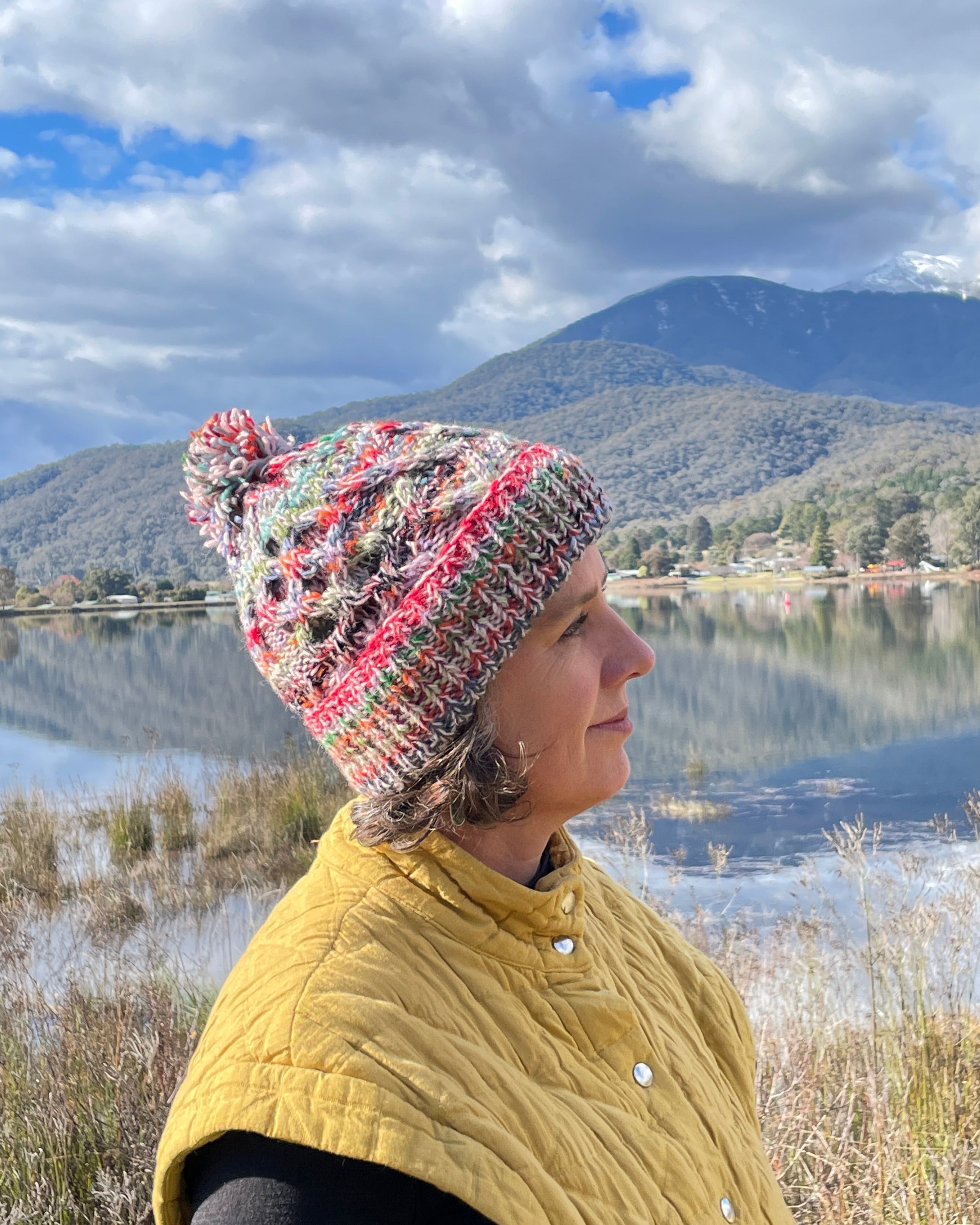 person wearing a multicolour wool beanie