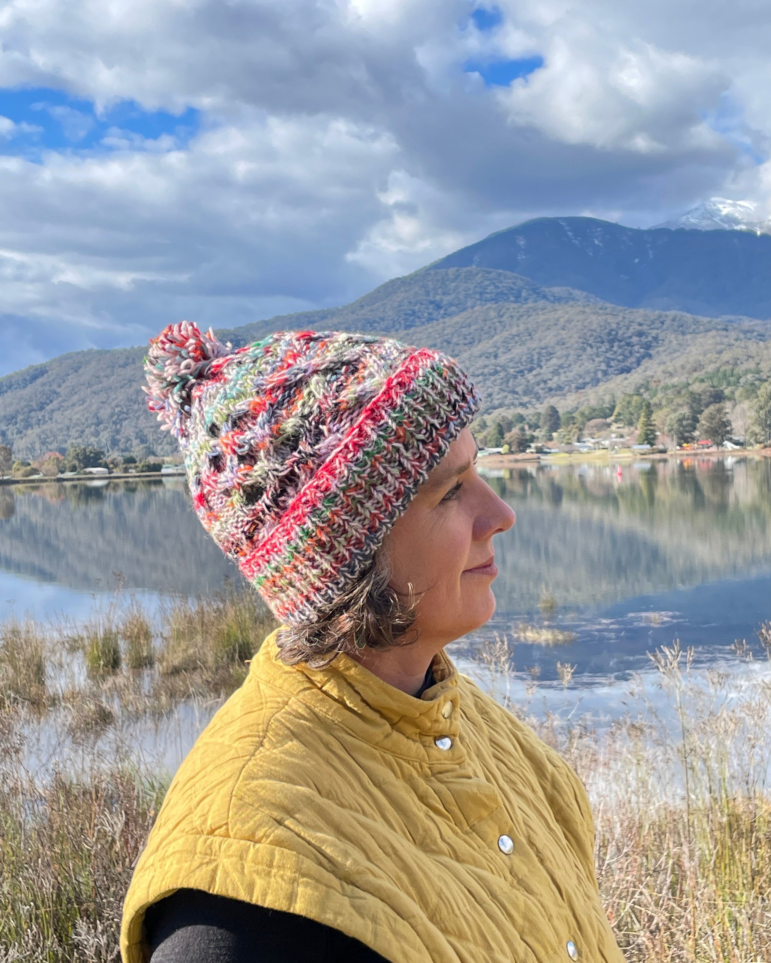 person wearing a multicolour wool beanie