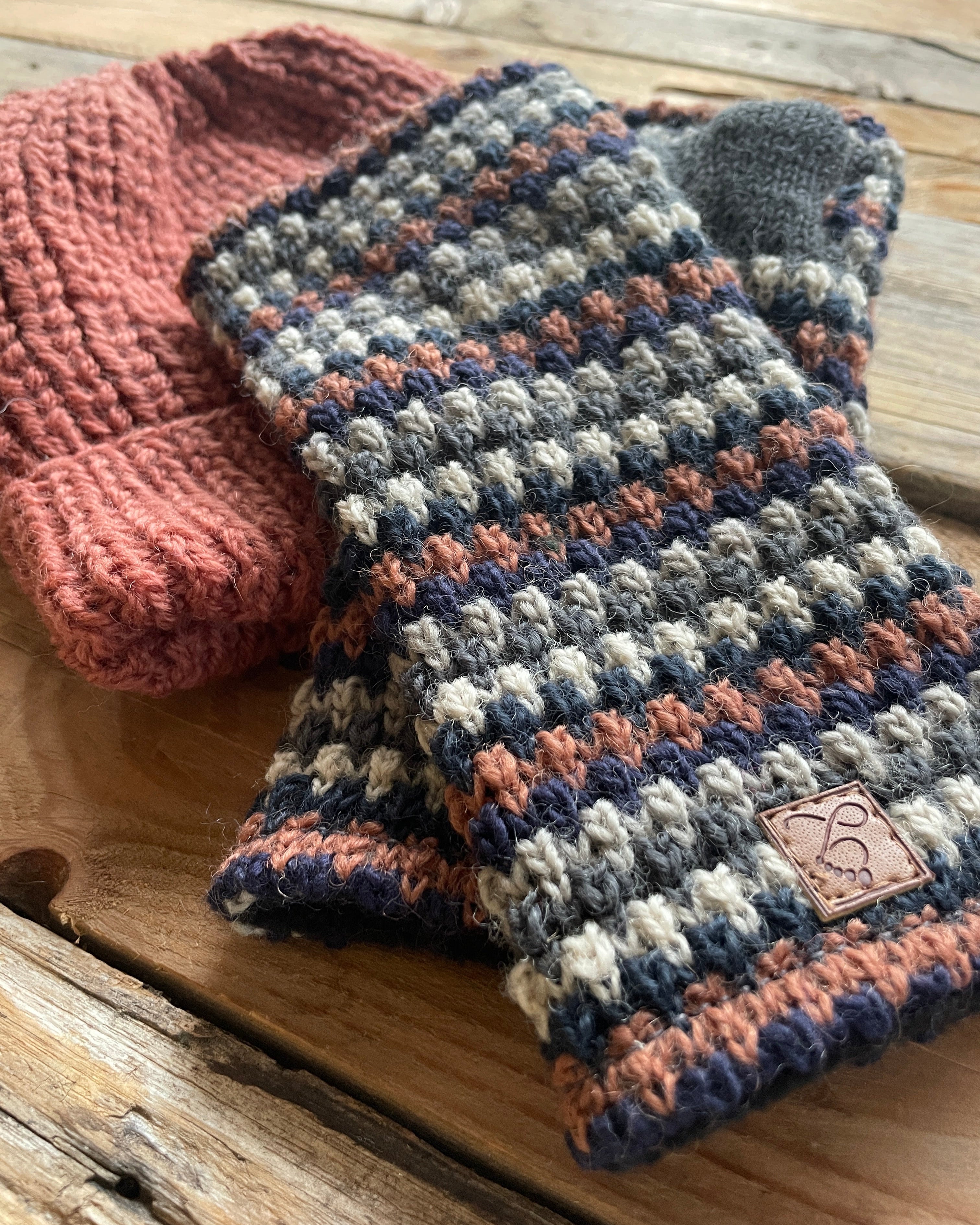 Knitted wrist warmer on a wooden surface