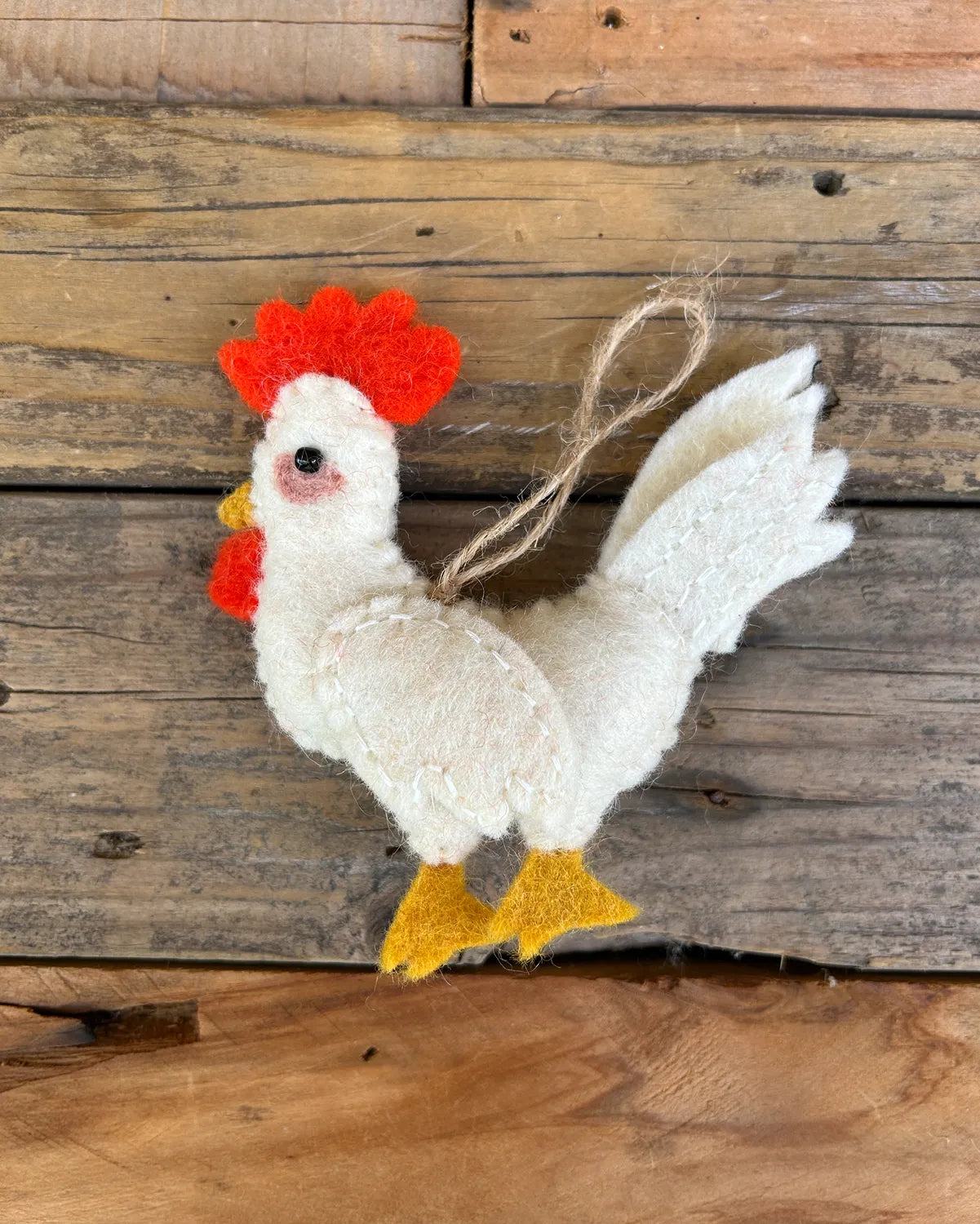 Decorative rooster ornament on a wooden background
