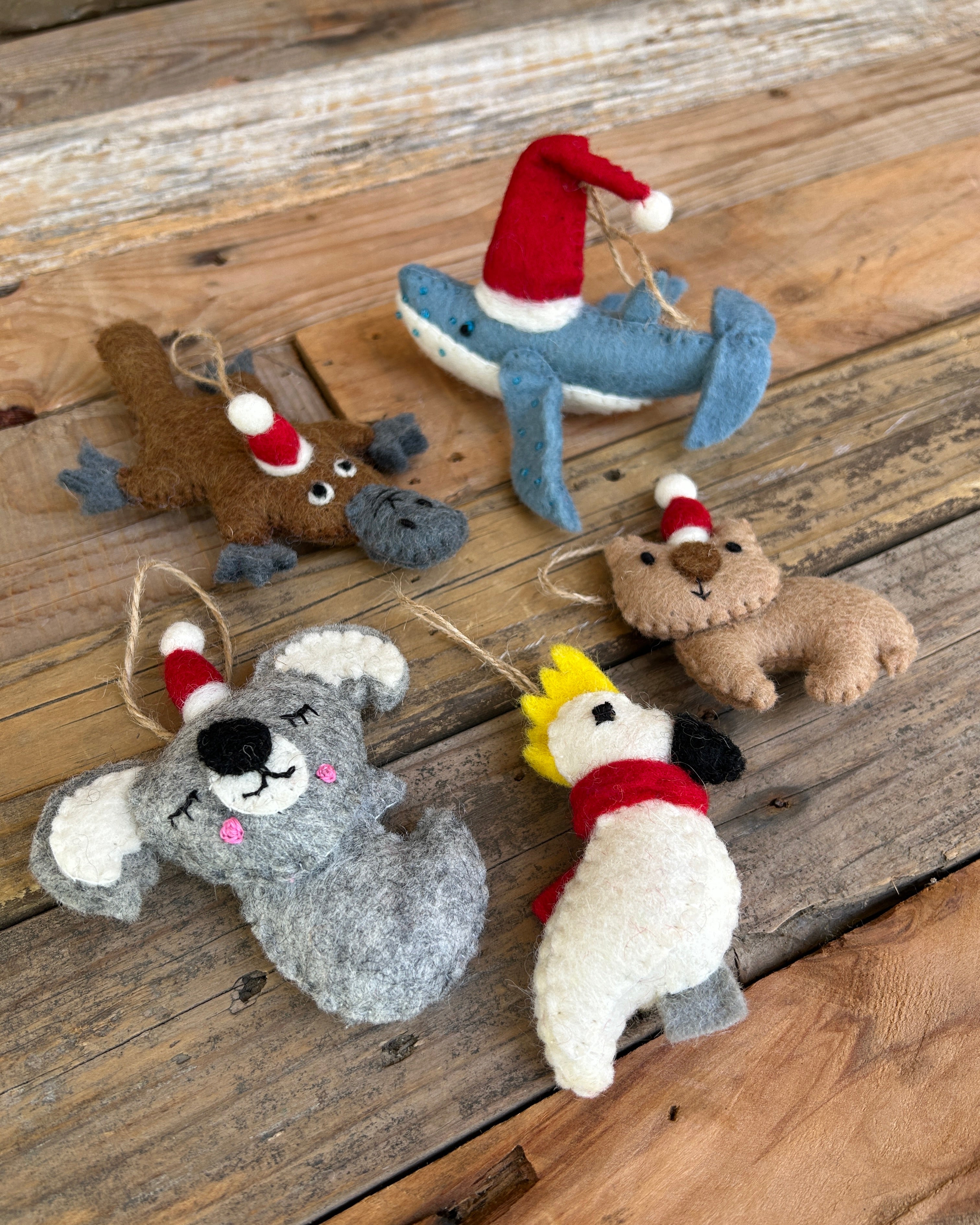 Set of felt australian animal ornaments on a wooden surface