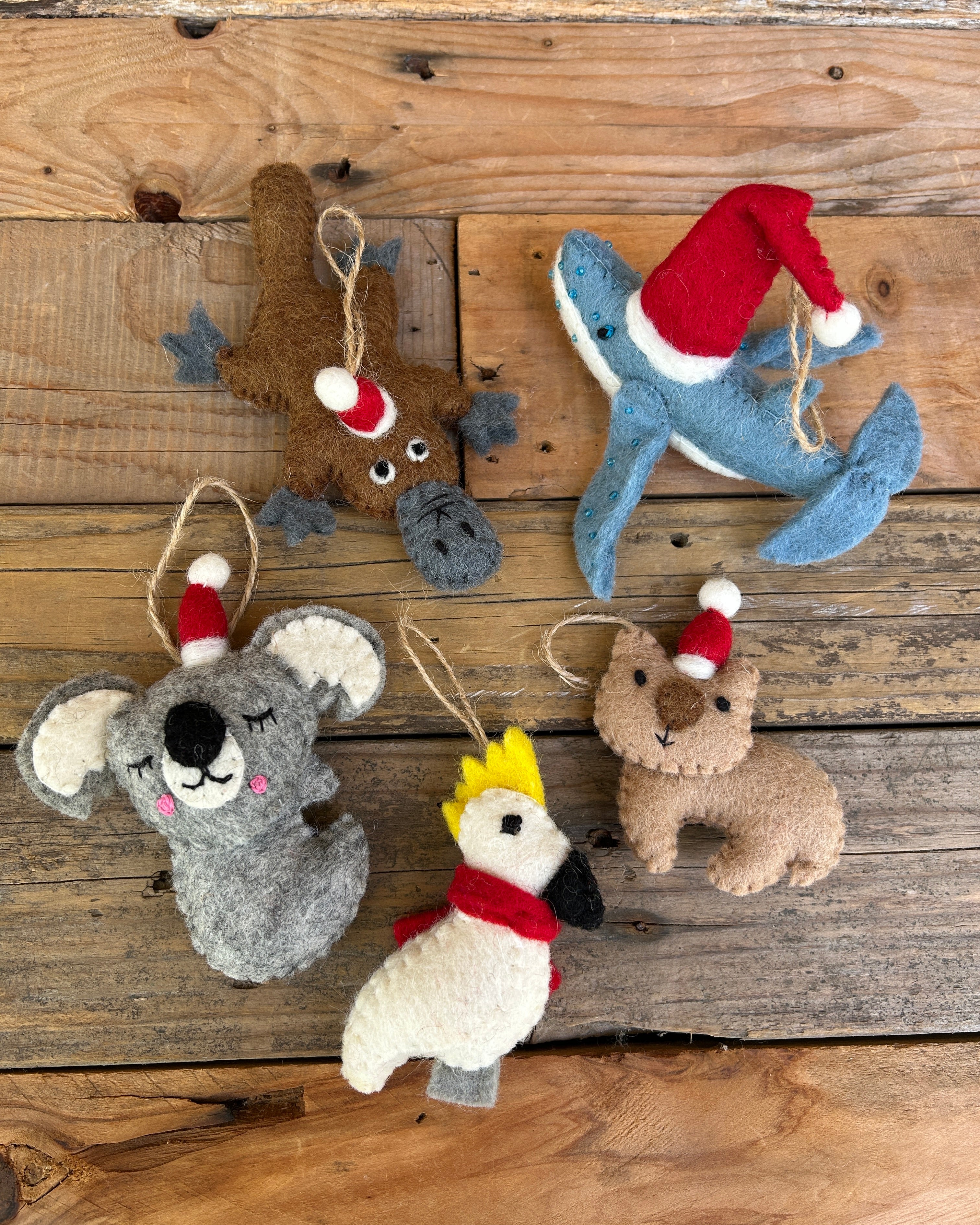 Set of felt australian animal ornaments on a wooden surface