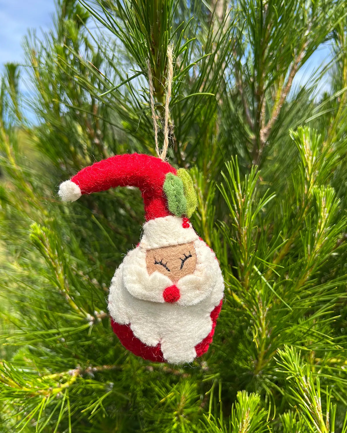 Felt Santa Claus ornament hanging on a Christmas tree