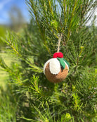 Felted Christmas pudding ornament hanging on a tree
