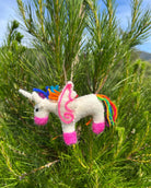 Colorful unicorn ornament hanging in a tree
