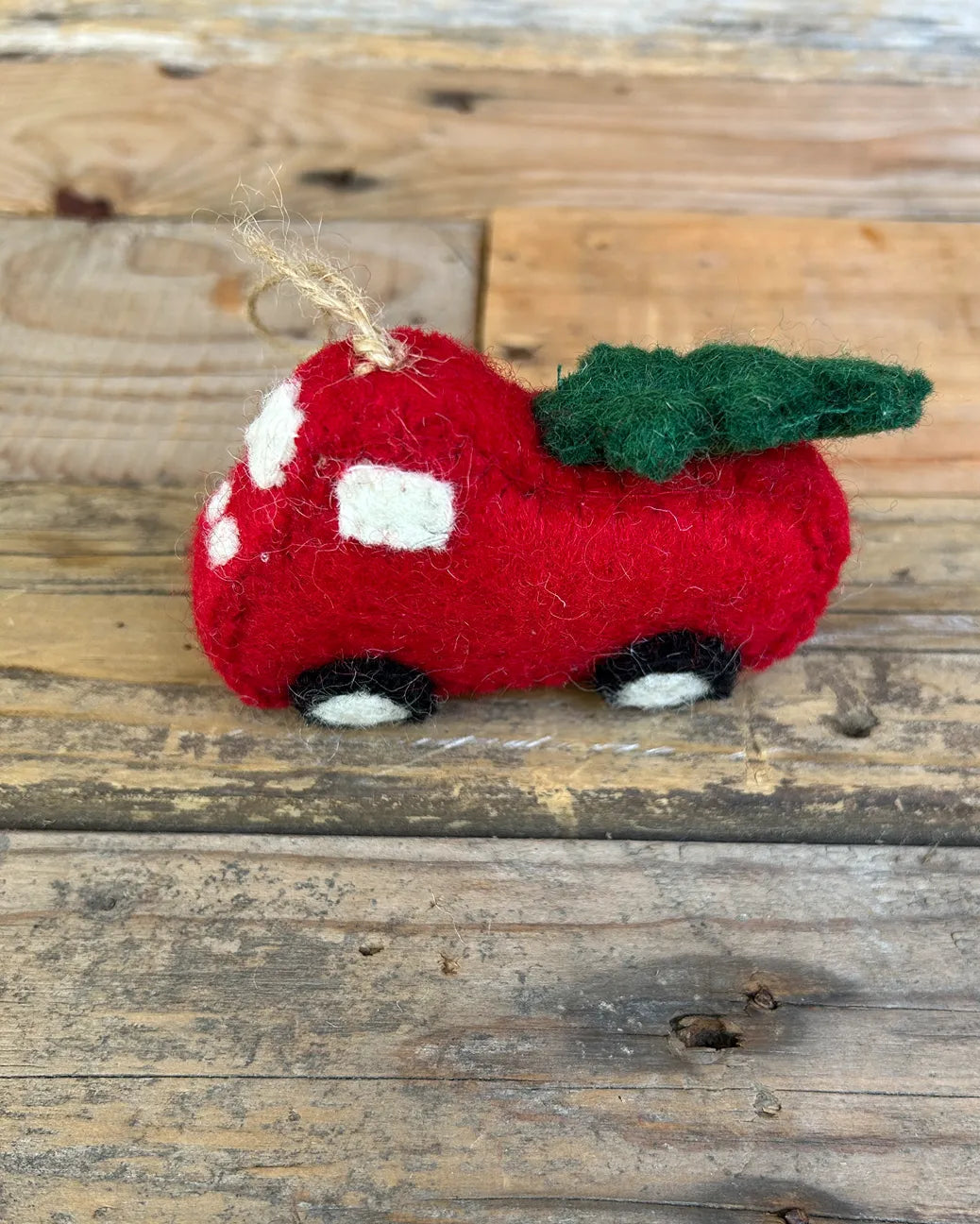 Red felt ute with Christmas tree on a wooden surface