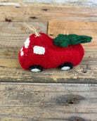 Red felt ute with Christmas tree on a wooden surface