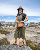 Woman standing on a rocky outcrop with a scenic background