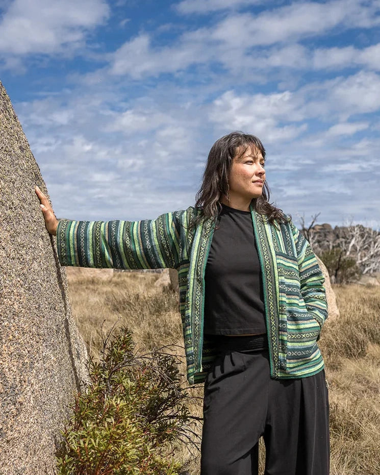 Person standing outdoors in a striped jacket